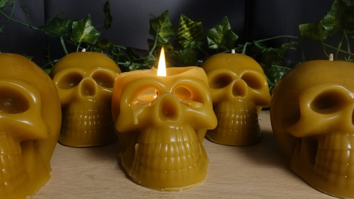 burning beeswax skull candle